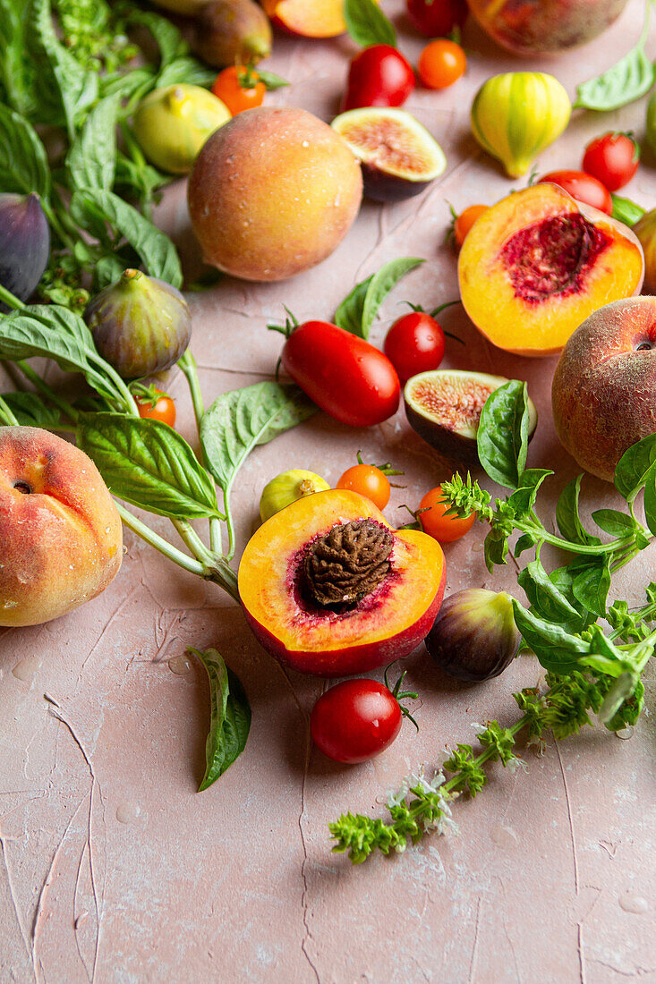 Summer produce featuring peaches, figs, tomato and basil