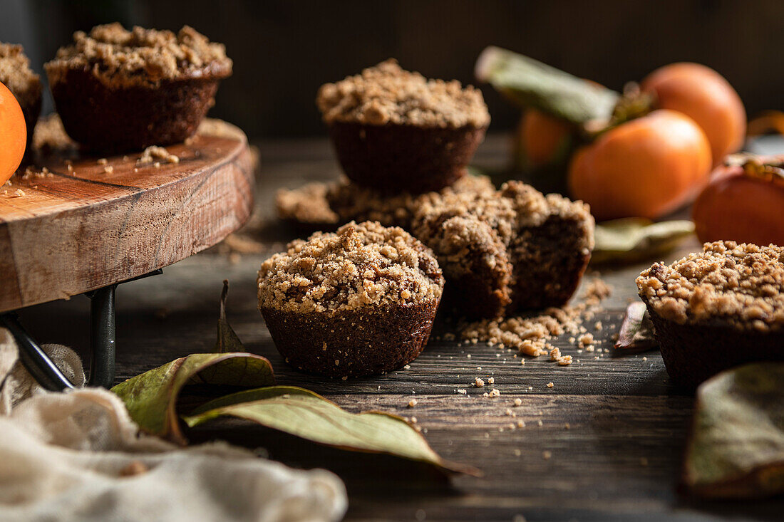 Persimmon Muffins in a rustic kitchen, with fresh persimmons