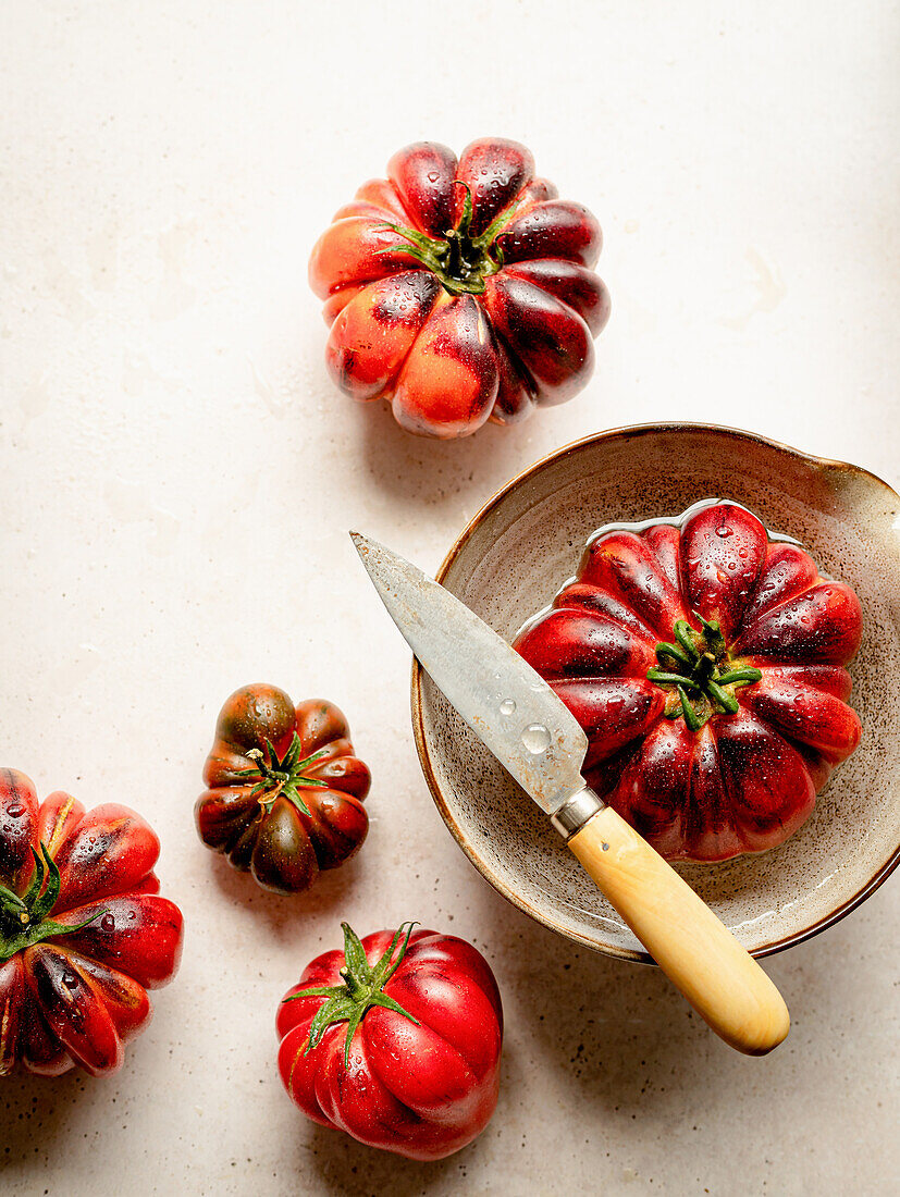 Several red tomatoes on a white table