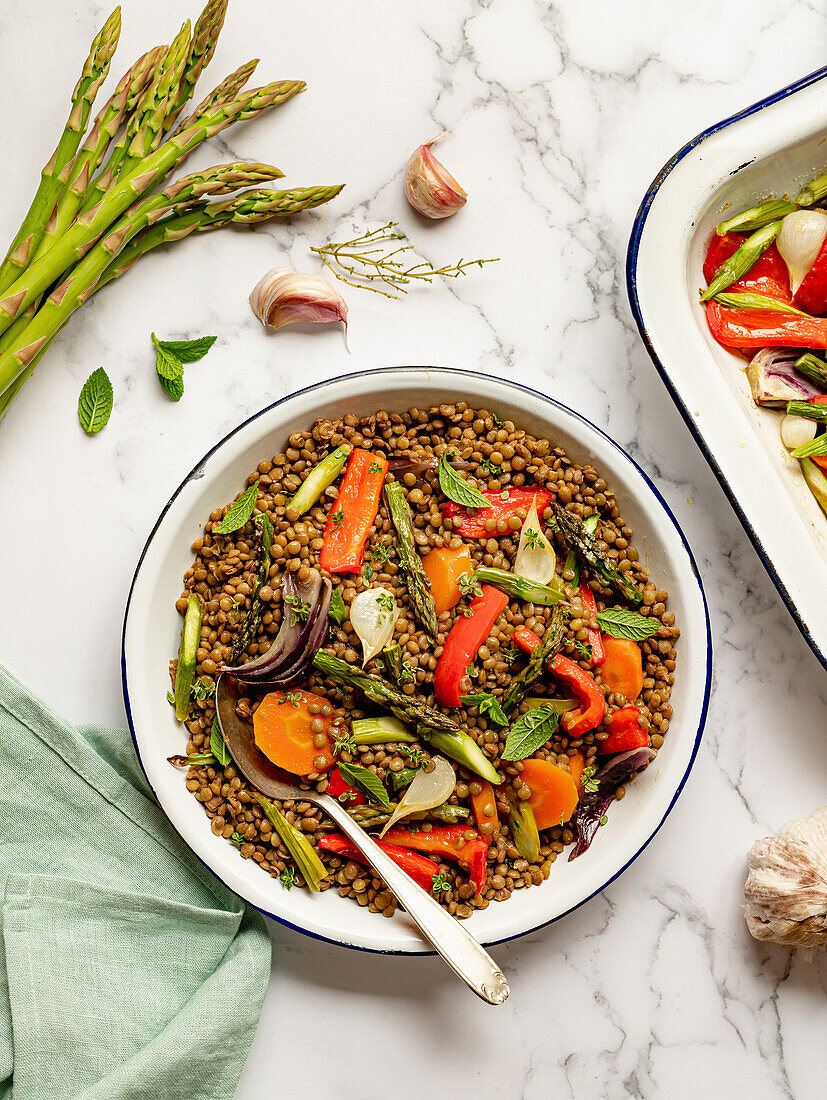 Lentil salad with assorted vegetables in bowl served on marble table for healthy lunch