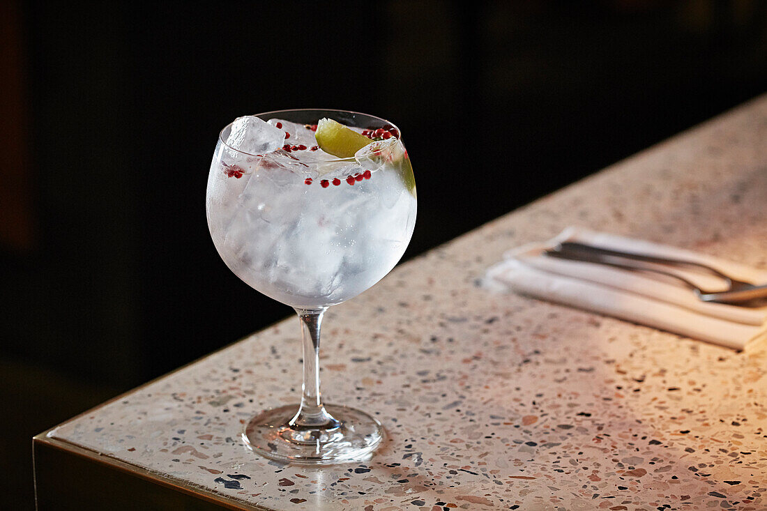Gin and tonic with red peppercorns