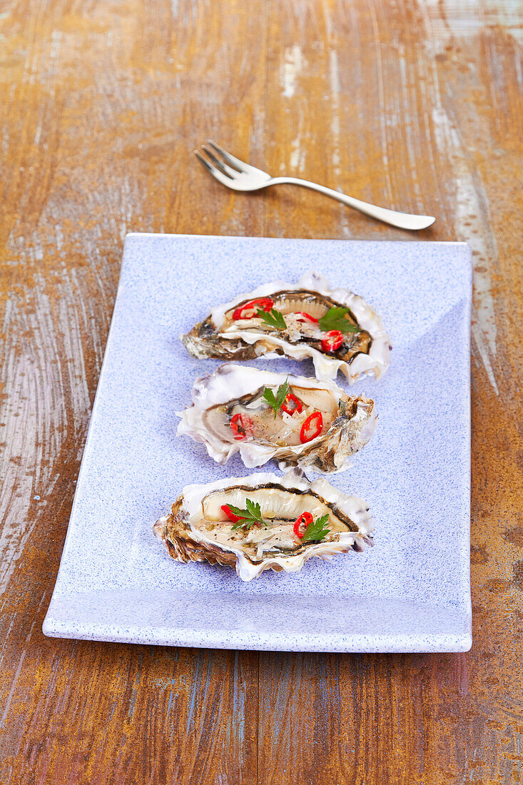 Oysters with chilli and coriander on a serving platter