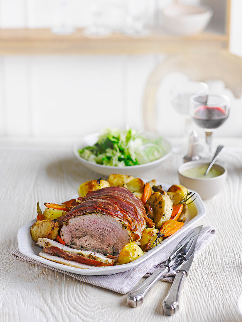 Herb roast pork with vegetable roasties and apple gravy