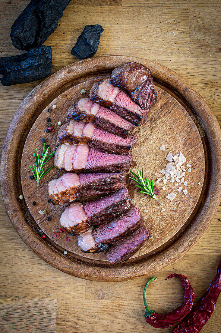 Grilled picanha (tail of beef) on wooden board