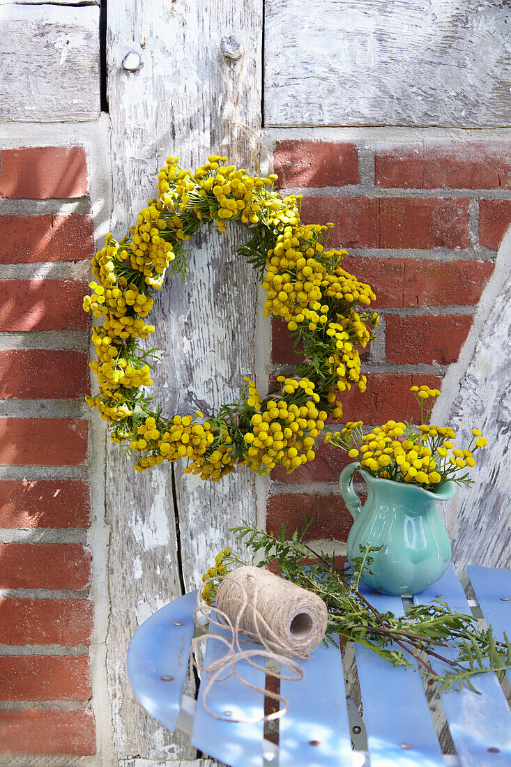 A wreath of tansy on brick wall