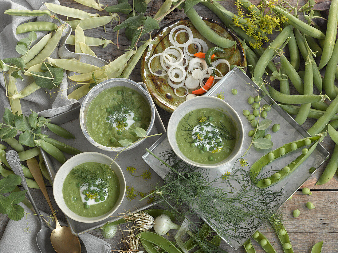 Bowls of Pea soup surrounded by ingredients