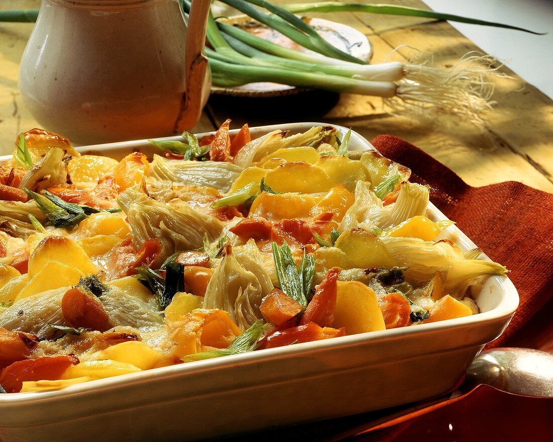 Vegetable gratin with potatoes, fennel, carrots, spring onions