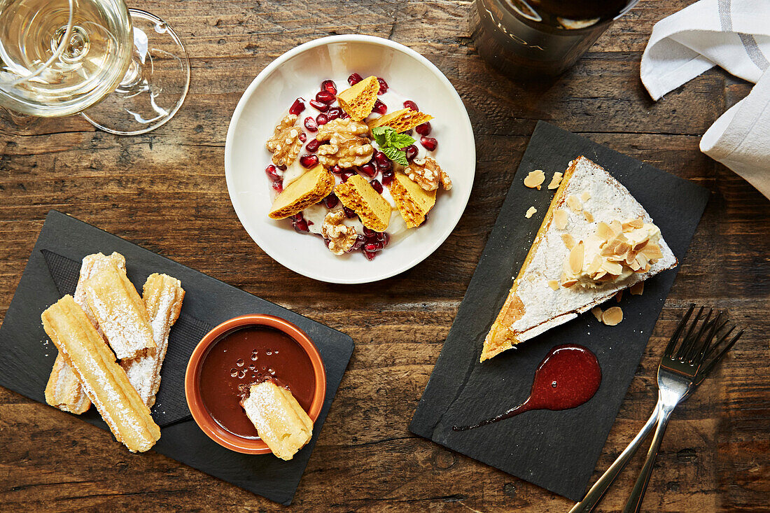 Churros, Brittle honeycomb pieces in yoghurt with pomegranate and almond tart