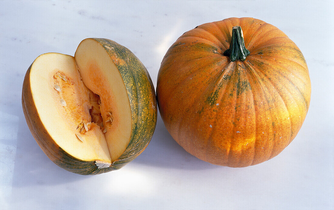 One whole and one cut pumpkin