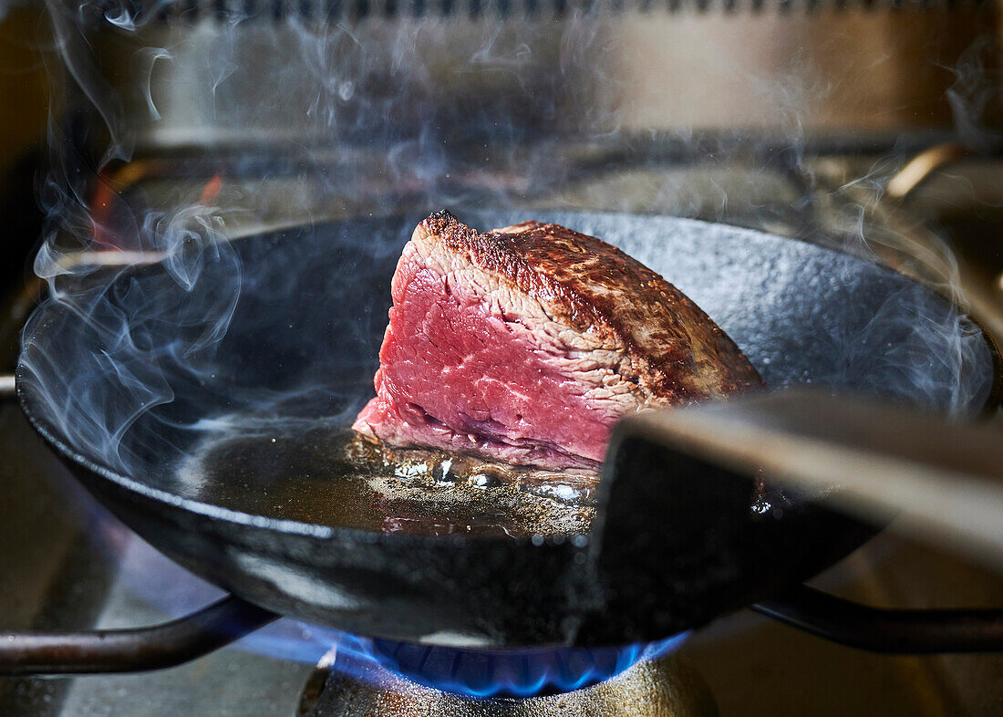 Frying beef fillet in a frying pan