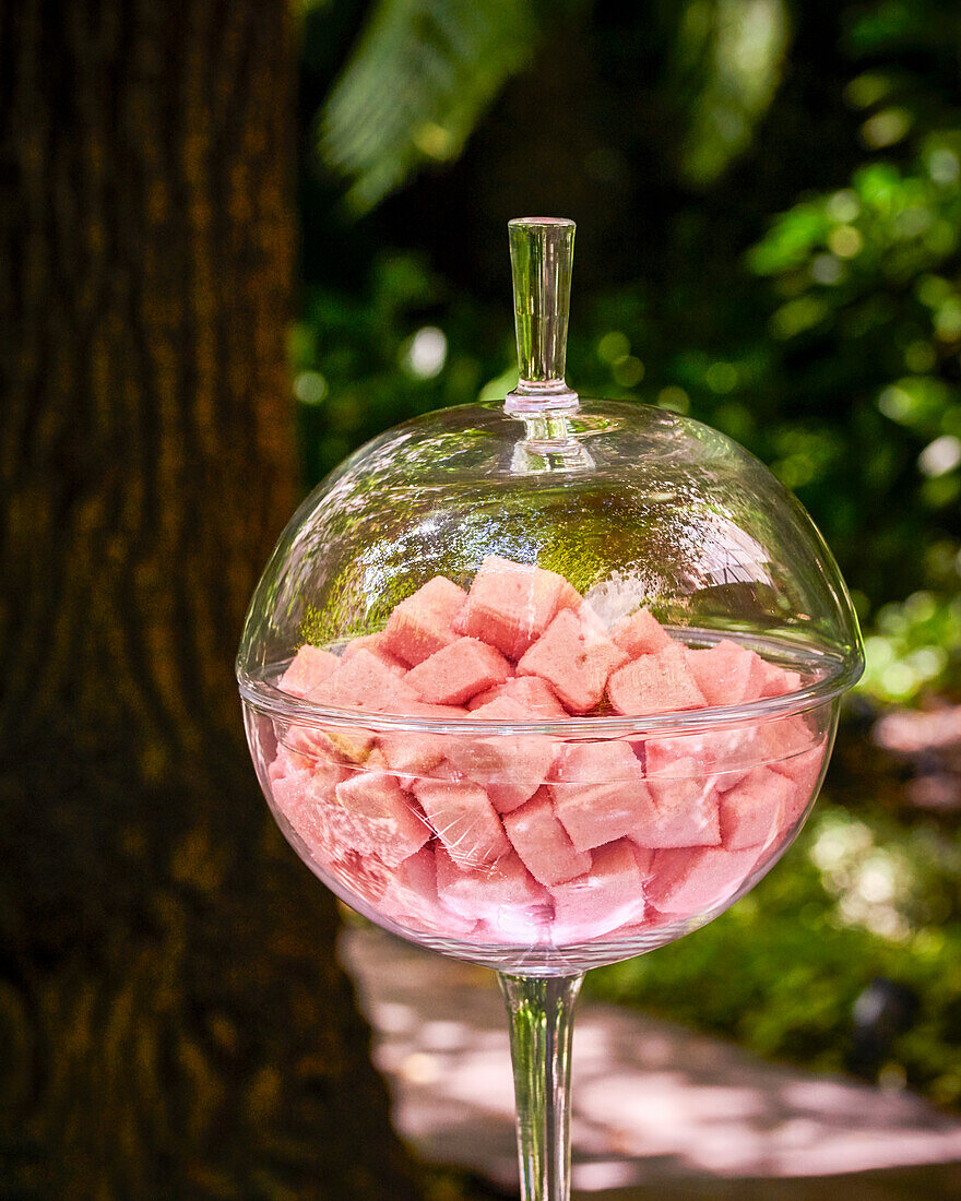 Pink marshmallows in decorative glass bowl with lid