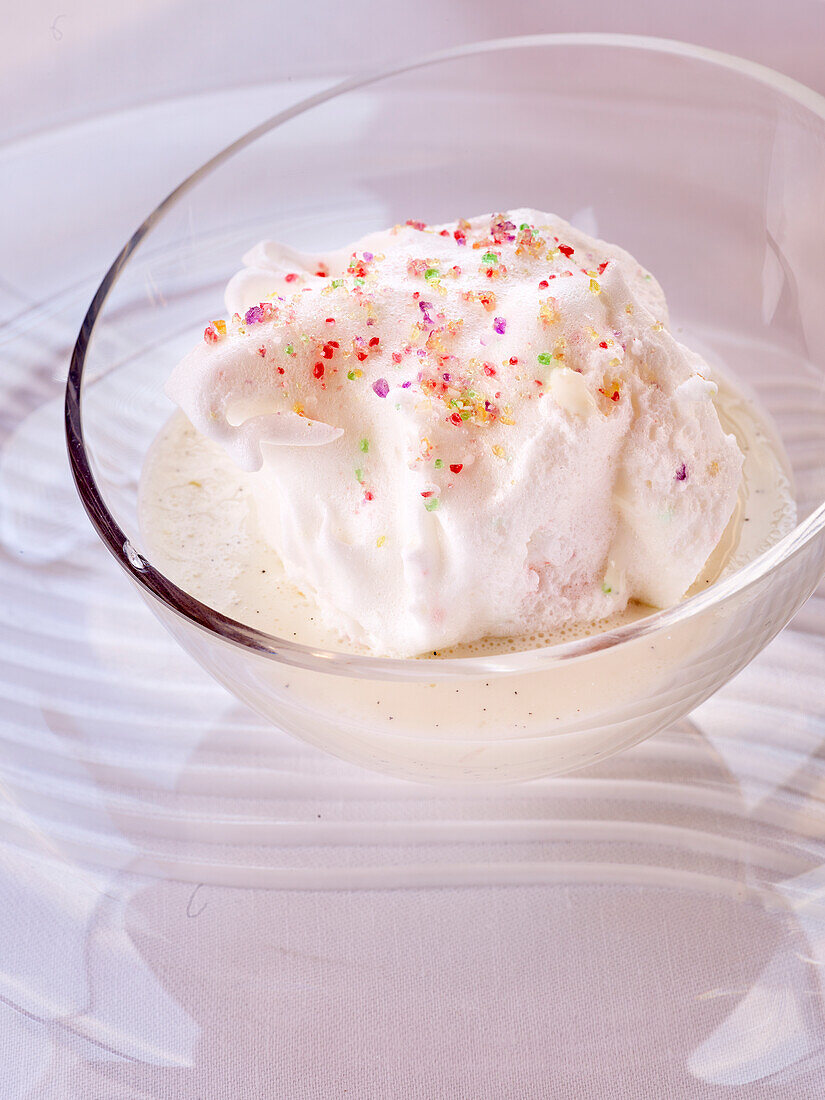 Ile Flottante (Floating island- ice cream dumpling on vanilla sauce) with colored caster sugar