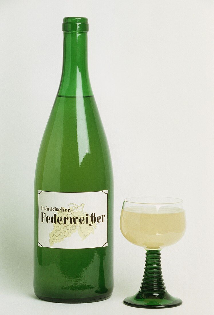 Federweisser (young wine) from Franken in glass and bottle