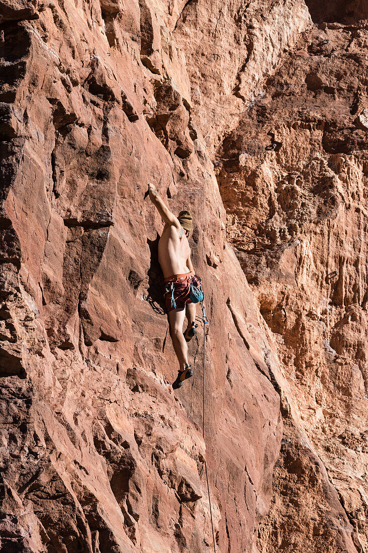 Climber climbing The Theater, Utah, USA