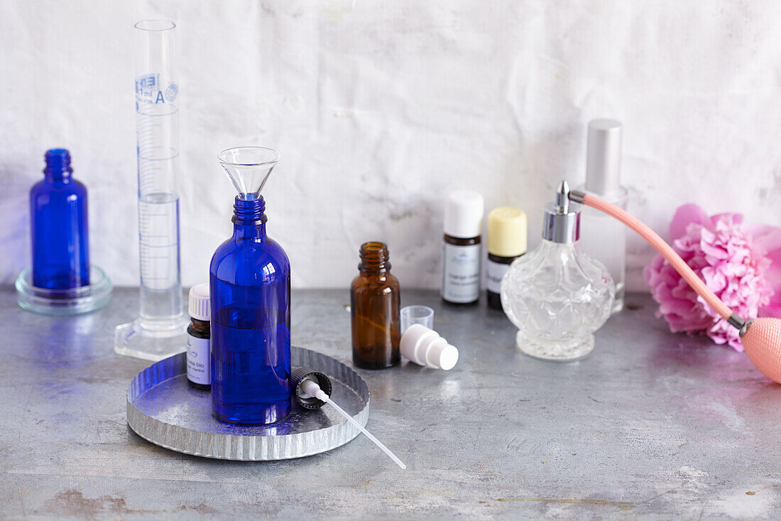 Blue dropper bottle, spray bottle, test tubes, and essential oils to mix spray