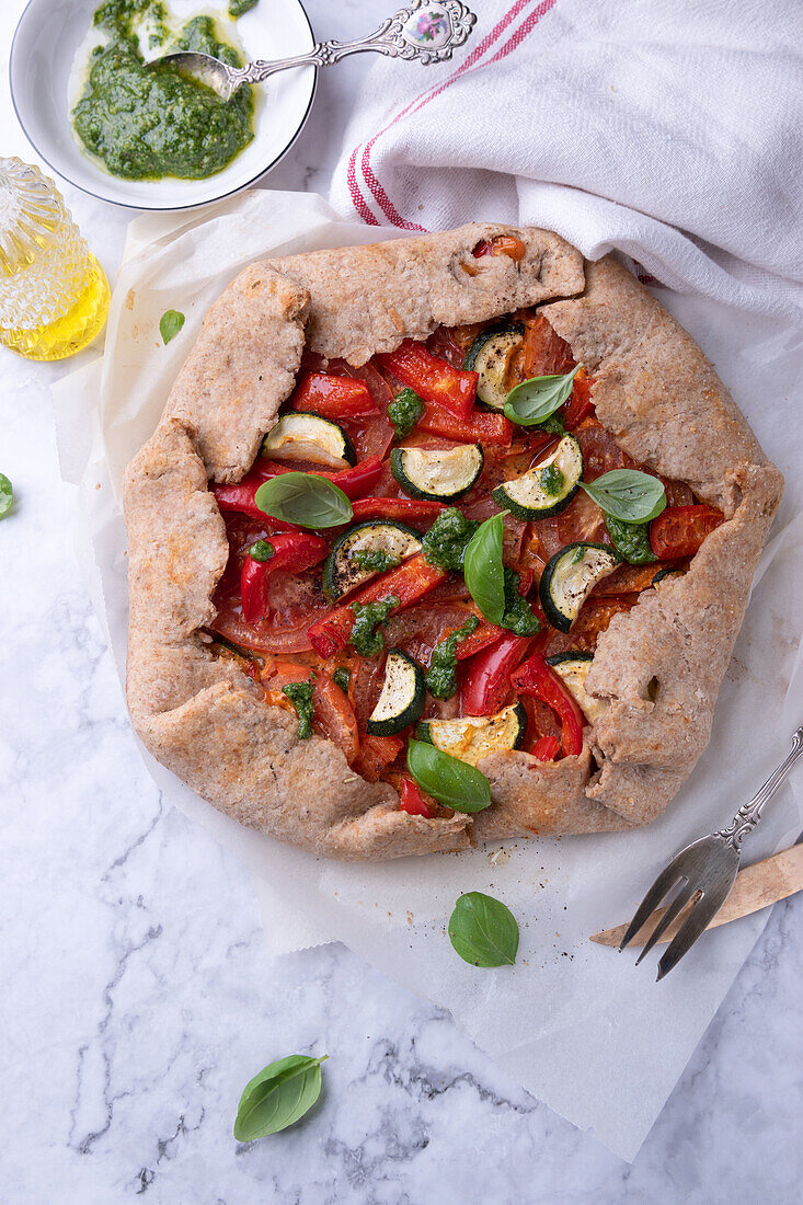 Vegan wholewheat spelt galette with tomatoes, peppers and zucchini