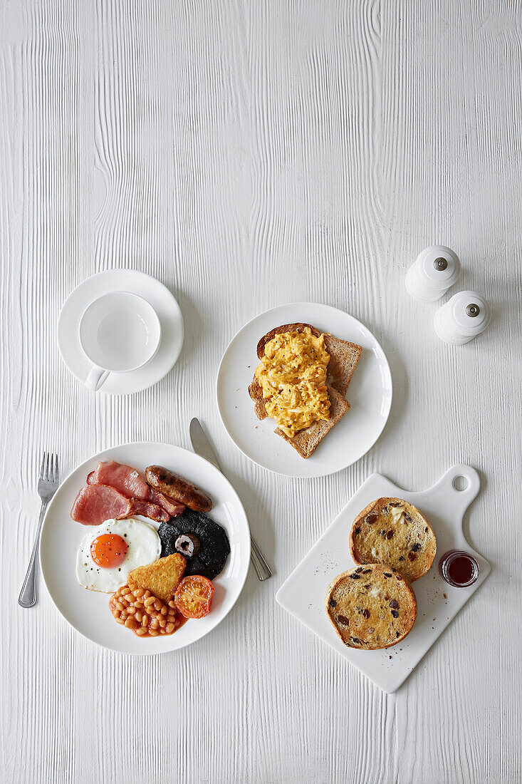 A full English breakfast, scrambled eggs on toast and a toasted fruit bun