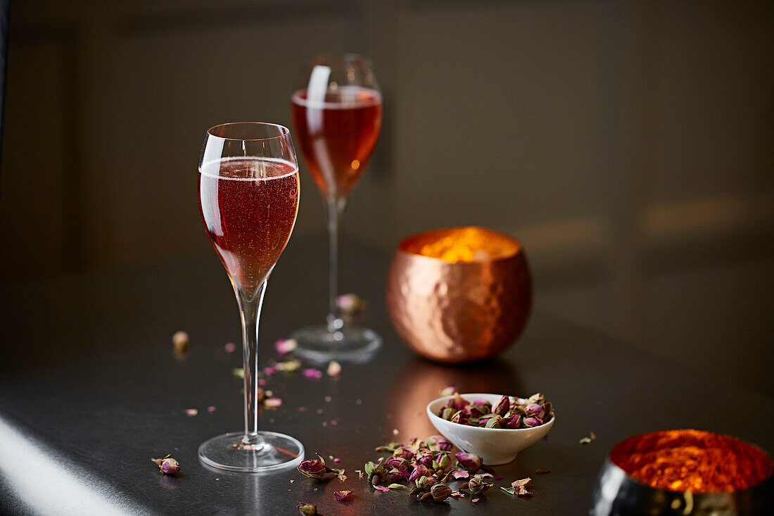 Two glasses of sparkling rosé on a bar