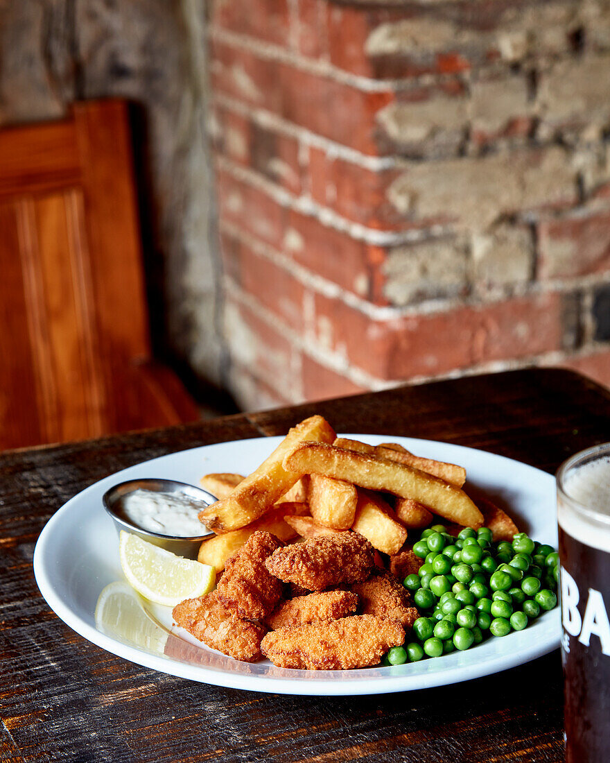 Chicken nuggets with fries and peas