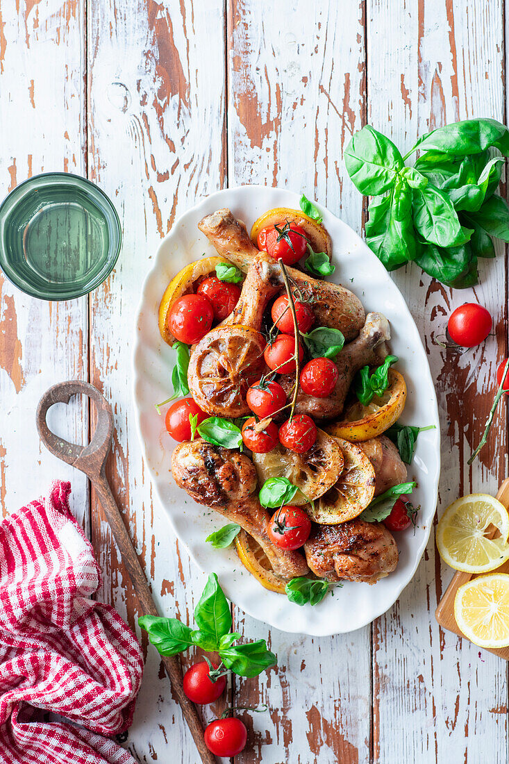 Chicken legs with lemons and cherries