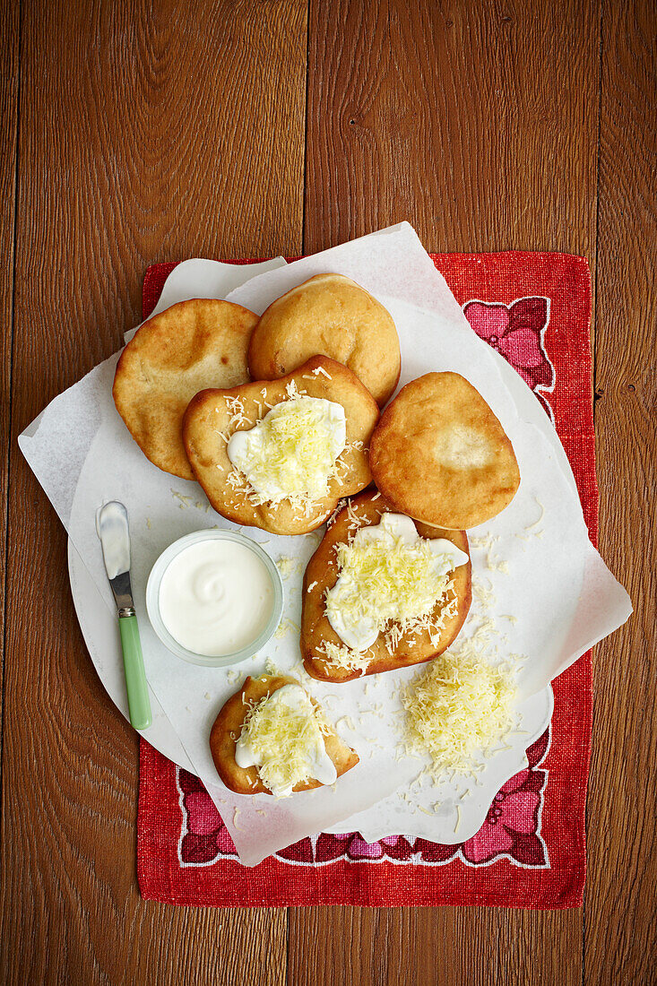 Langos - Hungarian fried potato flatbread with soured cream and cheese