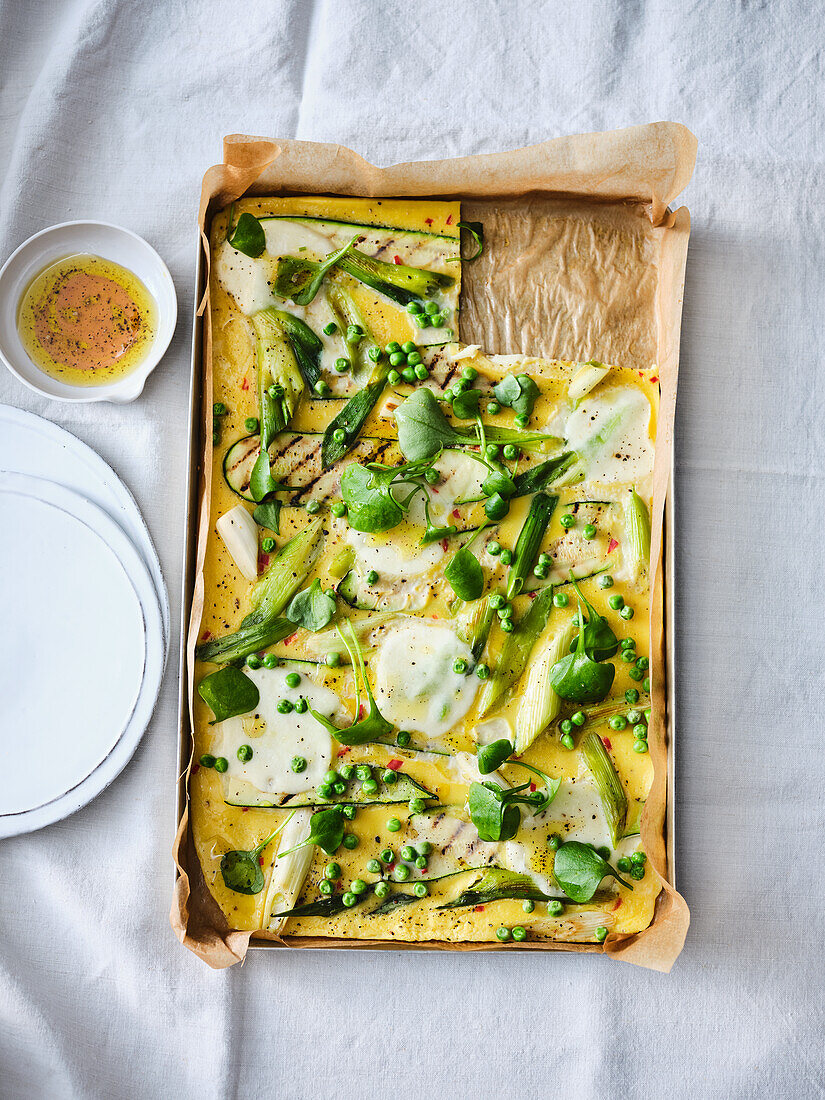 Oven pancakes with peas, courgettes and spring onions