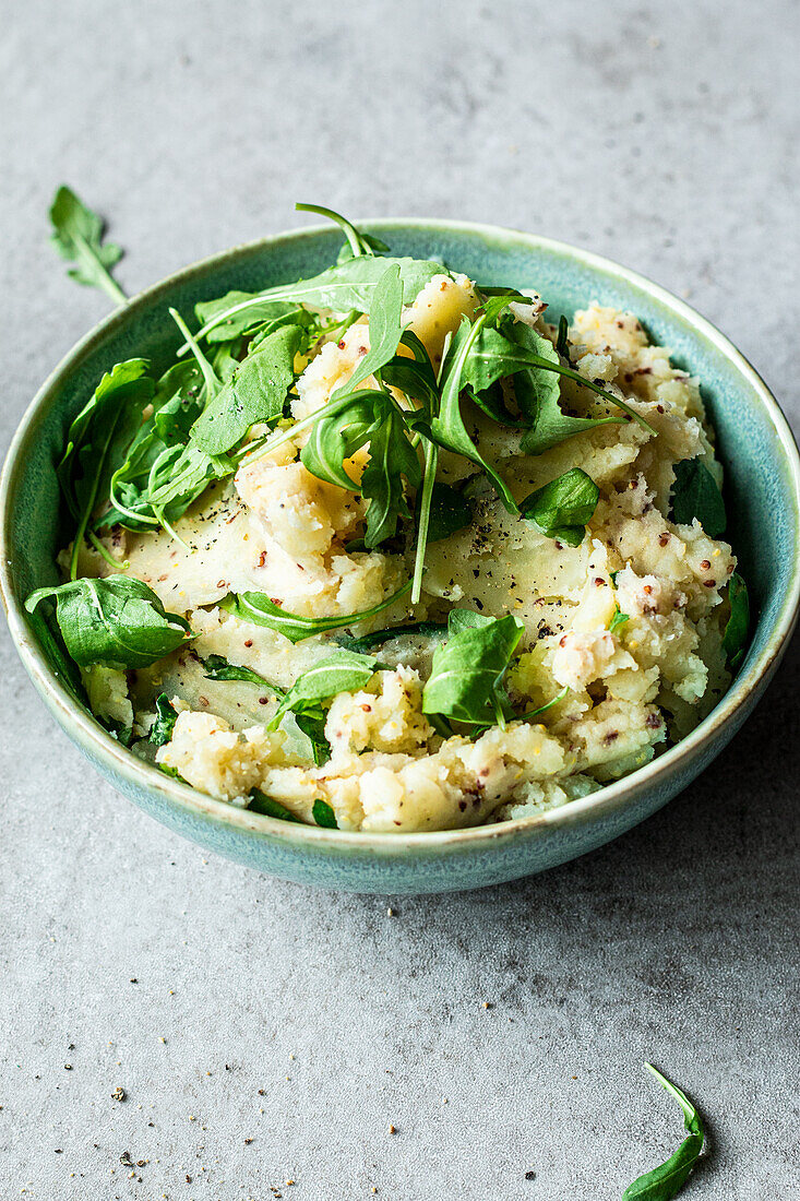Easy mashed potatoes with mustard seed and arugula