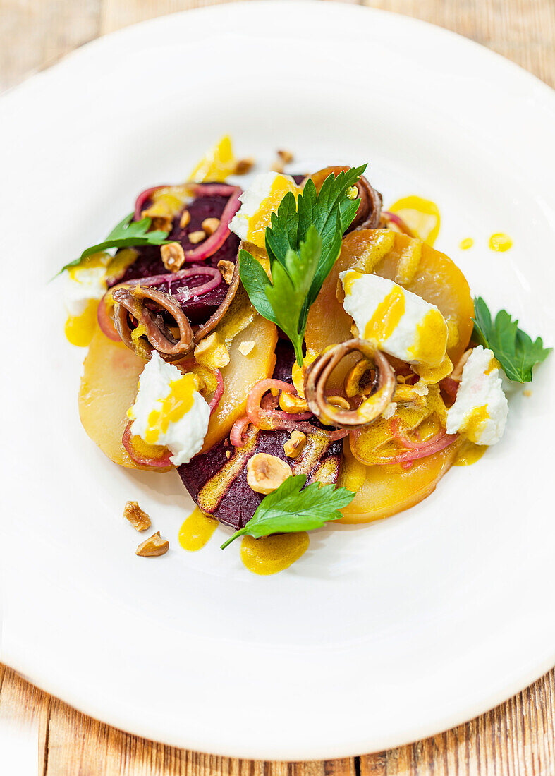 Salt baked beetroot salad, with goats curd, smoked anchovy, pickled shallots, hazelnuts and a mustard vinaigrette