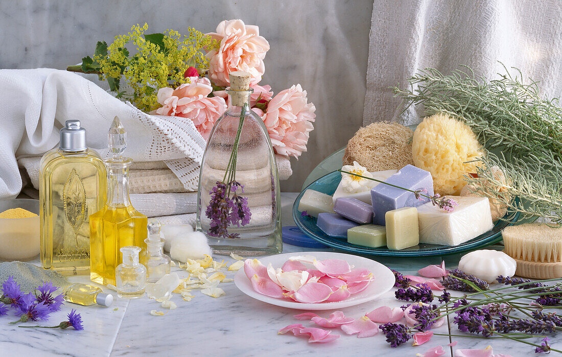 Still life with scented oils, lavender soap, bath salts, and natural sponge