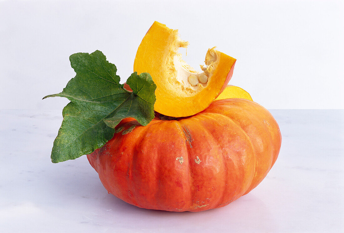 Orange pumpkin (Crookneck squash) on a light background