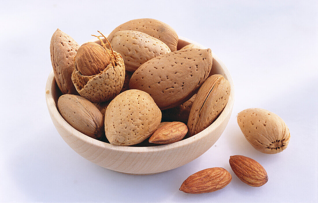 Bowl of almonds on a light background