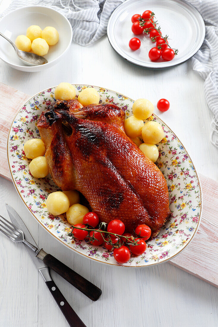 Roasted duck with potatoes and cherry tomatoes
