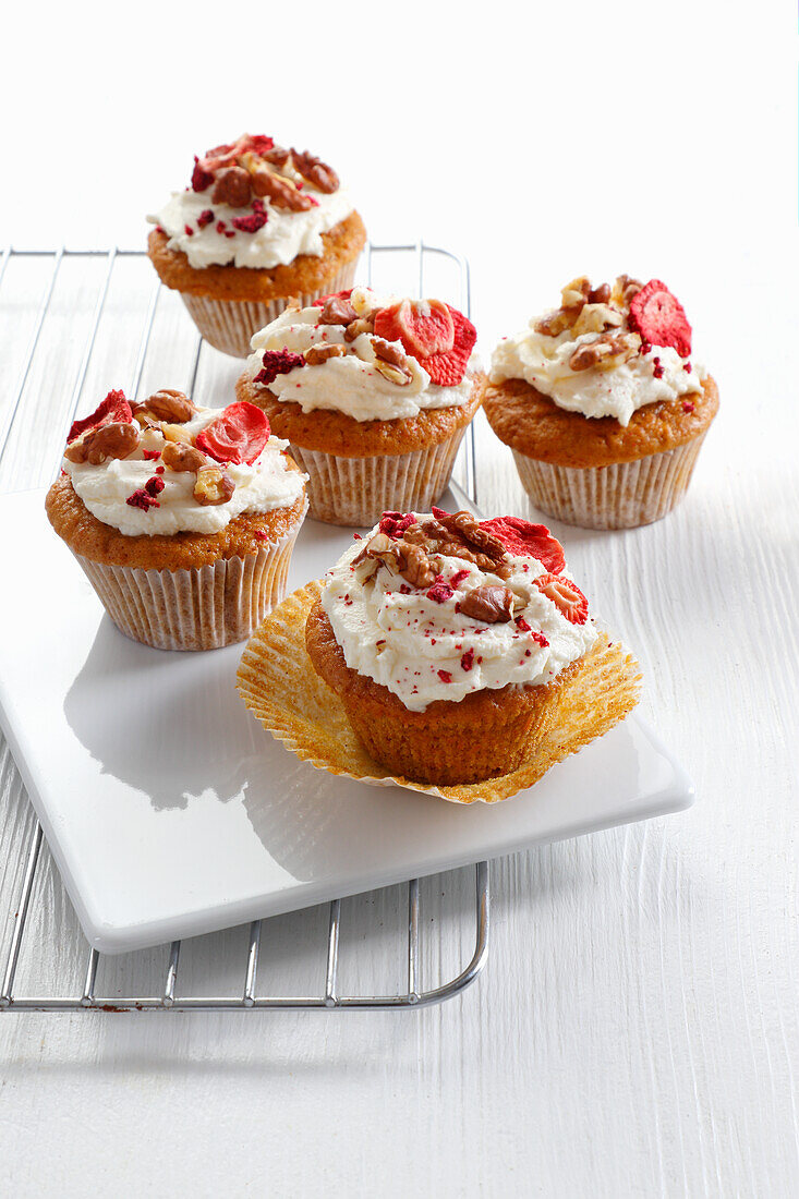 Carrot muffins decorated with cream and nuts