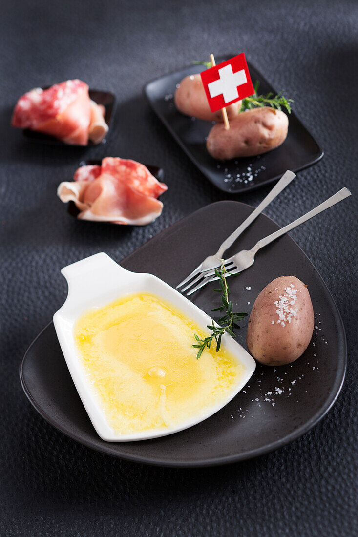 Raclette with potatoes and sausage