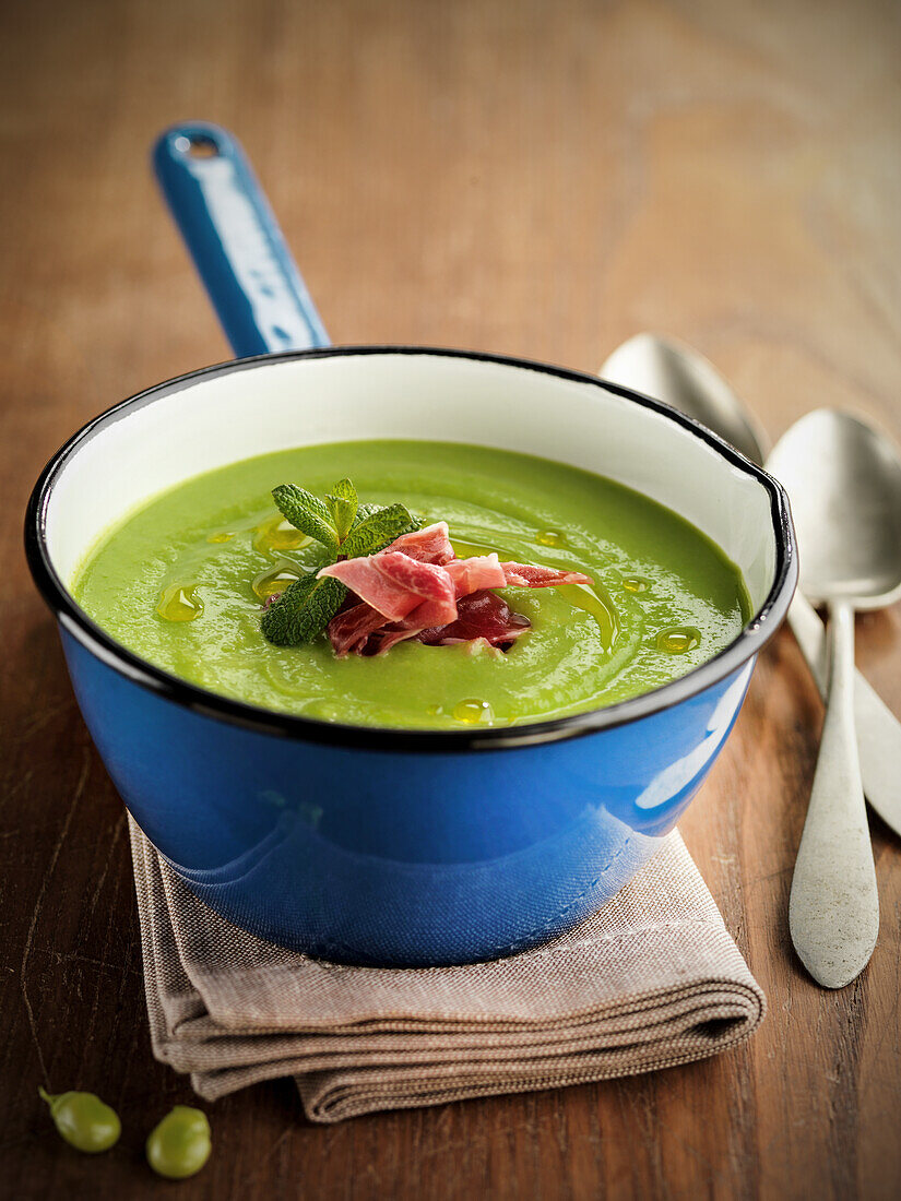 Cream of broad bean soup with ham and mint
