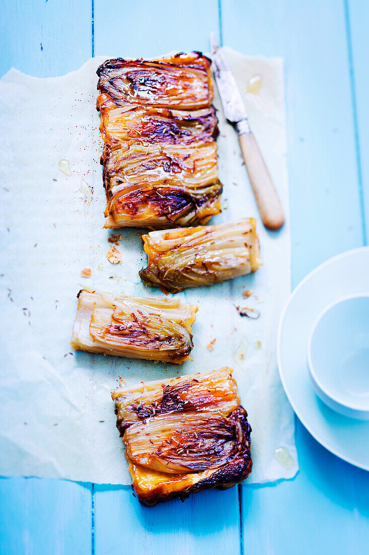 A rectangular puff pastry tart with chicory and cumin