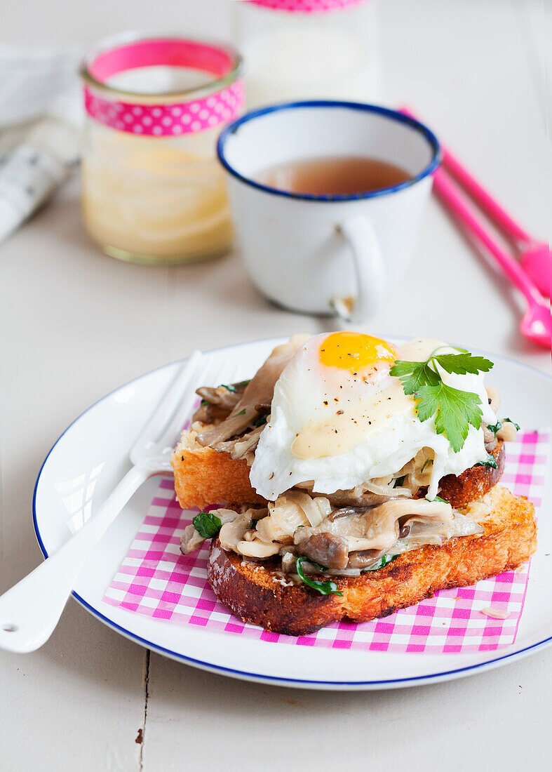 A slice of toasted brioche slice with mushrooms and a fried egg
