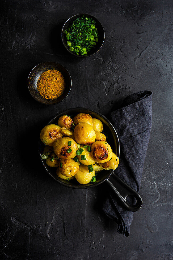Seasonal potato vegetables roasted in the pan and served with fresh green onion and dill herb