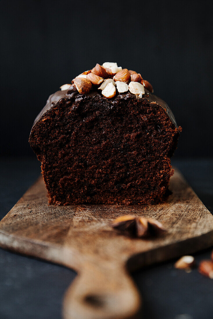 Spiced cake with nuts, sliced on a wooden board