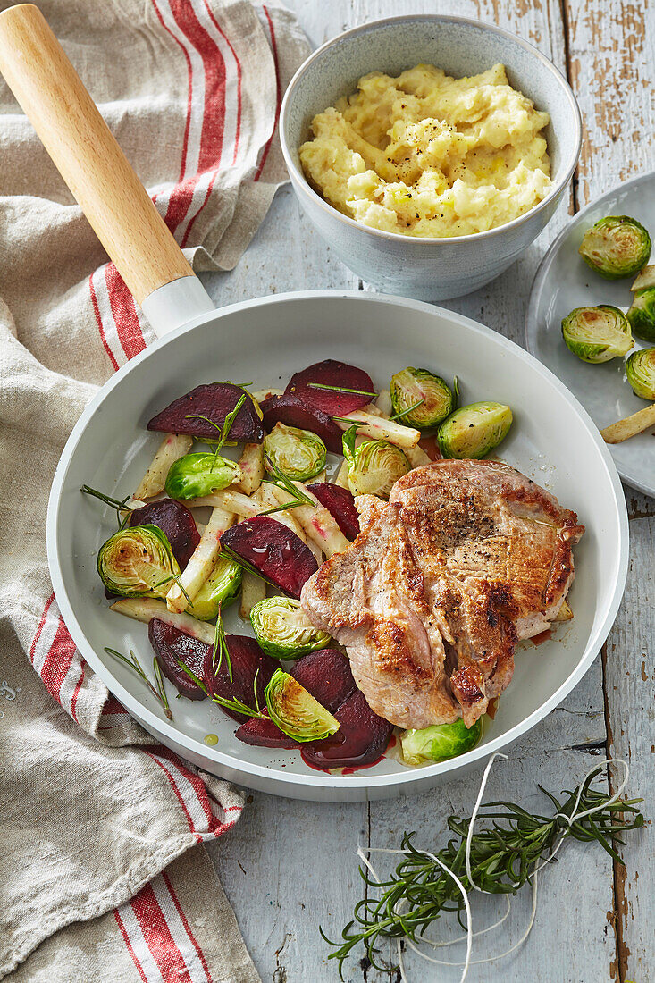 Pork loin chop with roasted vegetables and celery puree