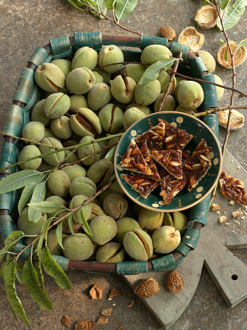 Fresh almonds and almond pastry made from shortcrust pastry with caramelized almond topping