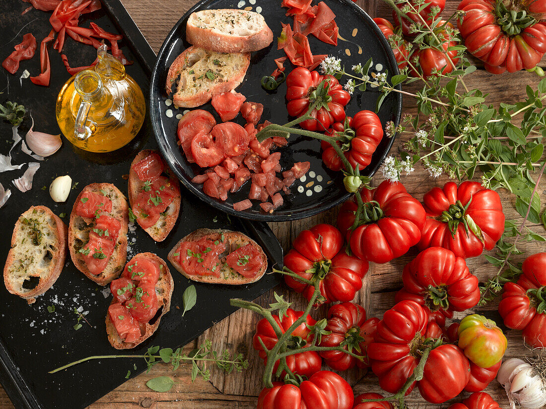 Tomato bruschetta surrounded by fresh ingredients