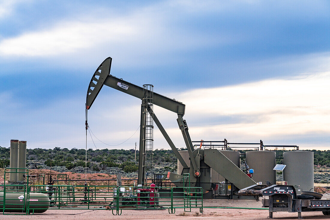 Oil well pump jack unit and storage tank battery