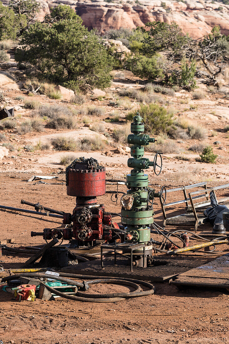 Partially disassembled blowout preventer on on oil well head