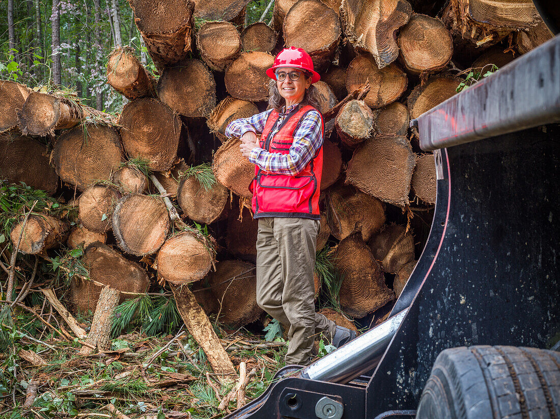 Forestry worker next to timber