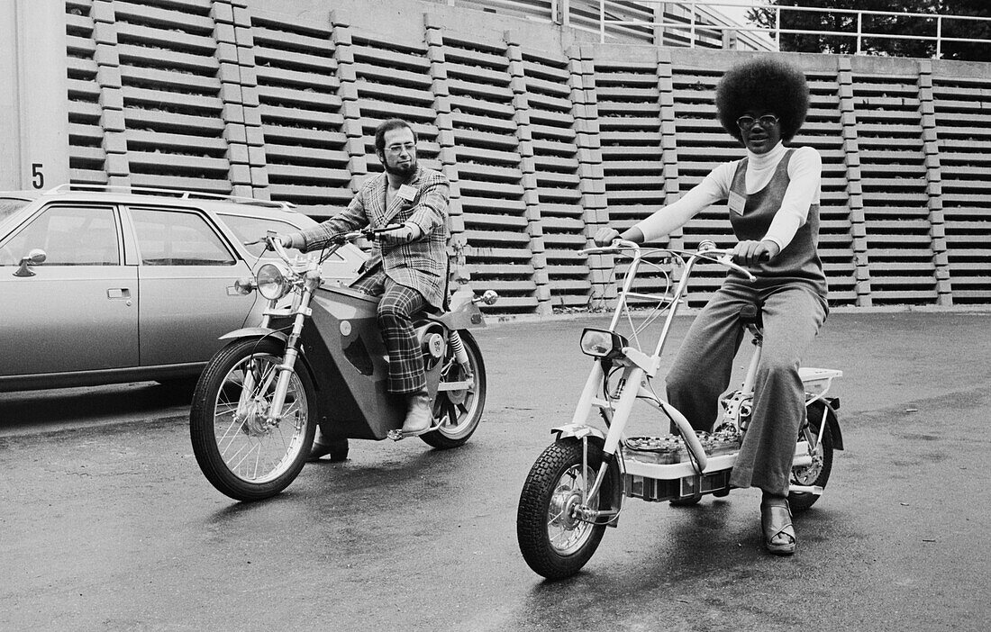 Man and woman riding electric motorbikes, 1974