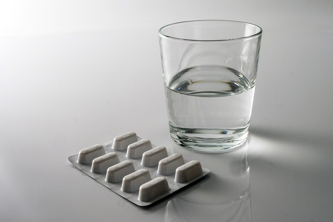 Pill blister pack along with a glass of water