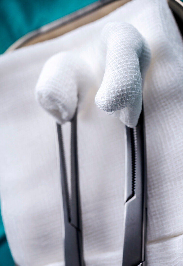 Surgical scissors with swabs on a metal tray