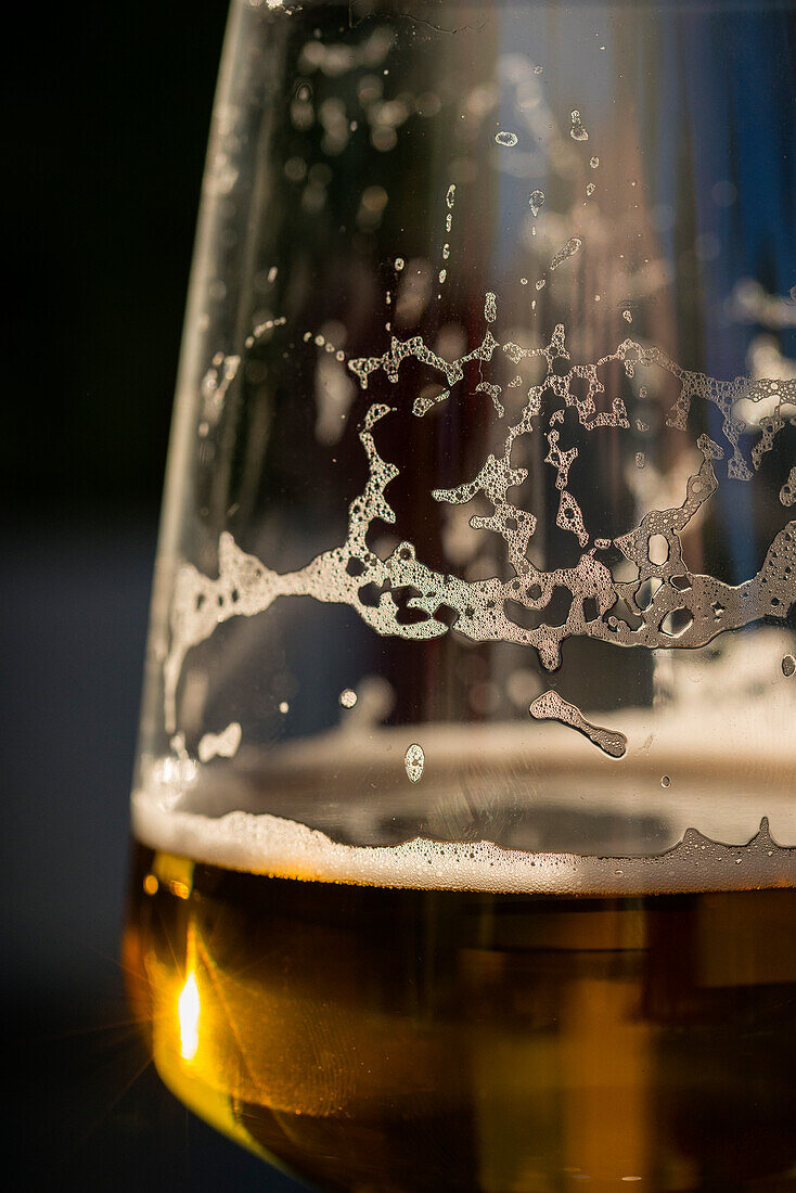 Glass with beer and remains of beer foam