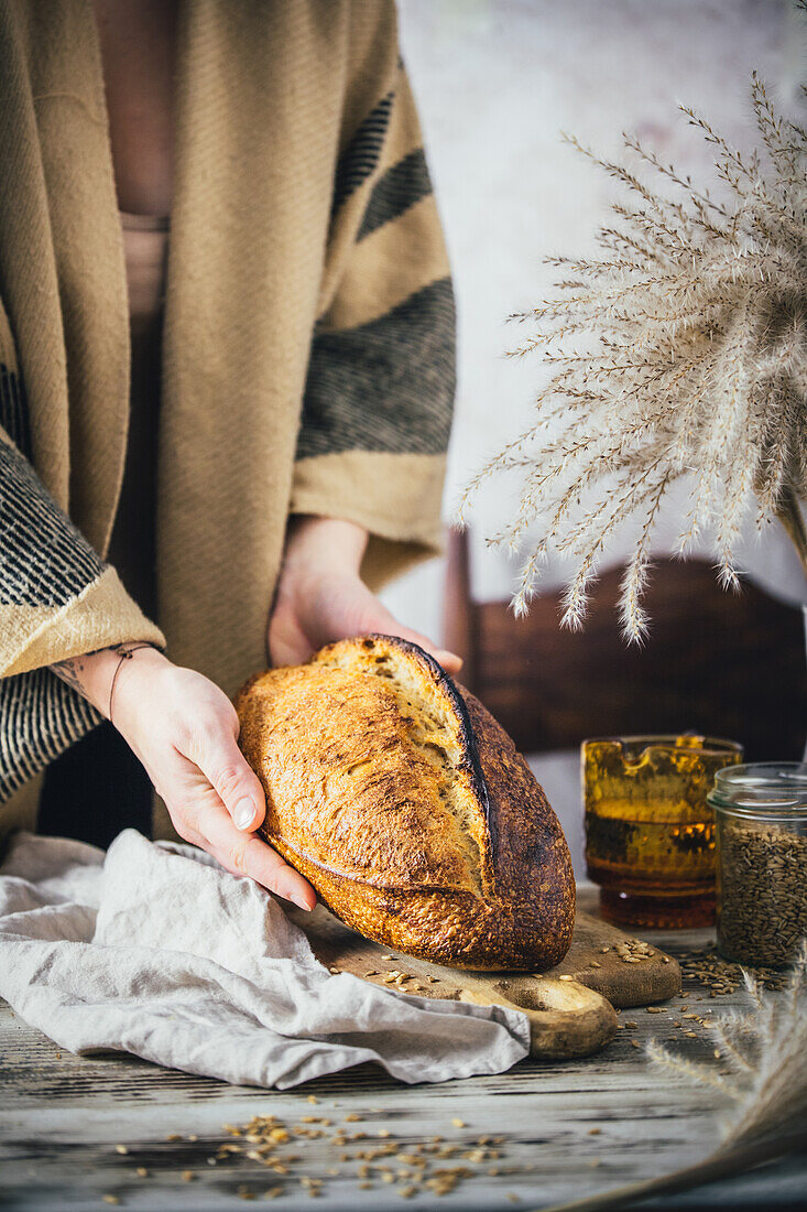 Women's hands holding crusty bread